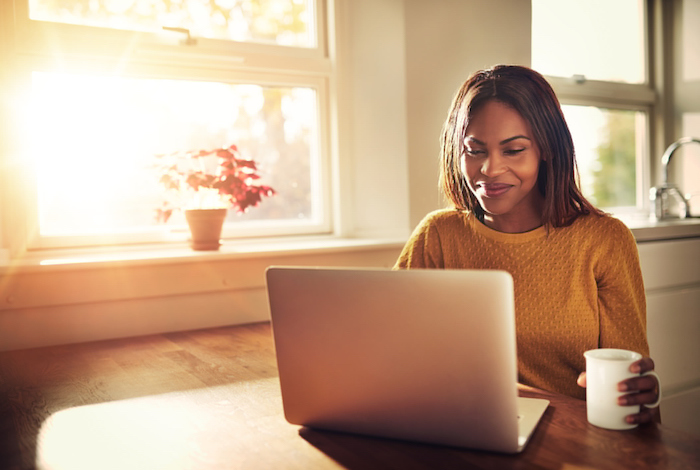 Smiling woman looking at laptop